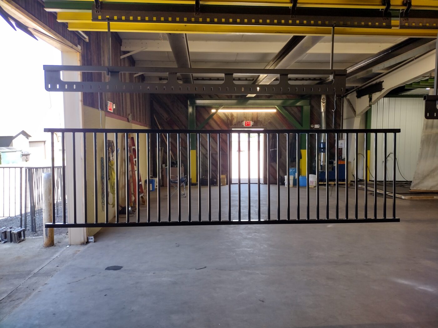 Long metal rack hanging in a warehouse